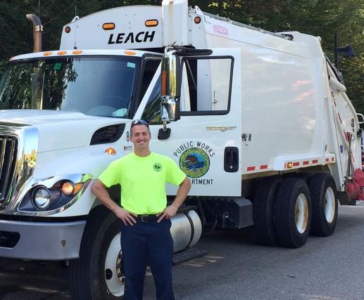 Employee next to DPW truck